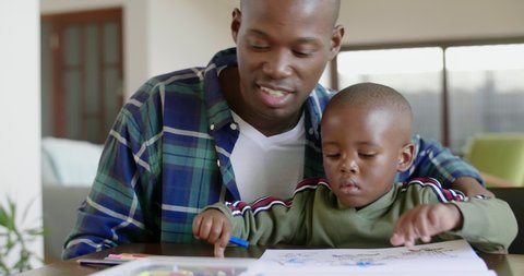 Black african family together at home, dad watching kid child boy son drawing pictures Vídeo Stock