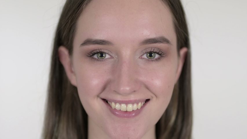 Close up of Smiling Woman Winking Eyes, White Background | Shutterstock HD Video #1040828024
