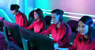 Team of asian teenage cyber sport gamers win the multiplayer PC video game on eSport tournament and give five to each other