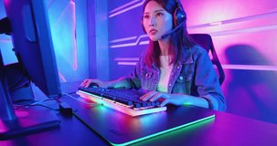 Young Asian Pro Gamer Girl Playing in Online Video Game