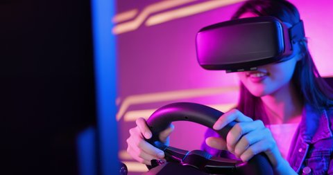 asian girl play car racing game with wearing vr glasses