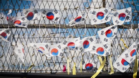 Paju, South Korea - Korean flag hanged by the Koreans along the demarcation line that separate the North and South. On the flag written messages of unification for both country.