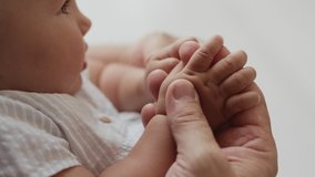 Happy Paternity and Recreation of Elder Caucasian Man with Healthy Daughter in Day Light Indoors. Grandparent and Baby Enjoy Family Time. Wrinkled Hand of Aged 50s Father and Little Palms of Young Boy - Powered by Shutterstock - Get 15% off with code: PIKWIZARD15