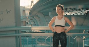 Portrait Young Sport Woman, close-up face girl running walking in the modern place in city in summer sunny day under sun light. 4K slow motion video