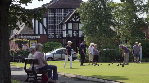 PORT SUNLIGHT, MERSEYSIDE/ENGLAND - JULY 16, 2019: Village scene as people play crown green bowls in Port Sunlight, Wirral, England
