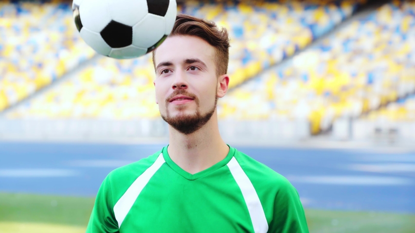 smiling football player throwing ball