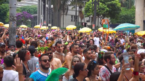Sao Paulo, Brazil - March 02 2019: Crowds follow and sing along with block parade known as Electric Trio. Historic city center of Sao Paulo during carnival of Brazil, is a popular holiday.