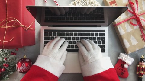 Top view of Santa typing on laptop 