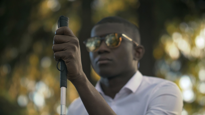 Blind black african man in the park.blind, blindness,Visually impaired