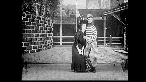 CIRCA 1920s footage of a theatrical vaudeville play with a man and woman performing a classic show of interplay.