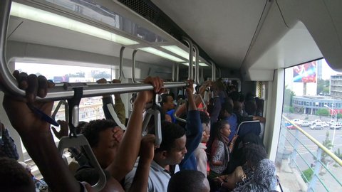 ADDIS ABABA – MARCH 2019: Train passengers travel on Chinese built light rail system (elevated metro line) in Addis Ababa, infrastructure and transportation development in Ethiopia, China in Africa