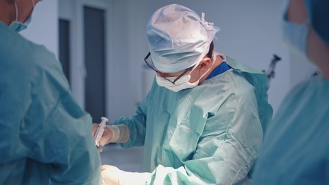 Bone marrow operation. Surgeons team working during stem cells operation