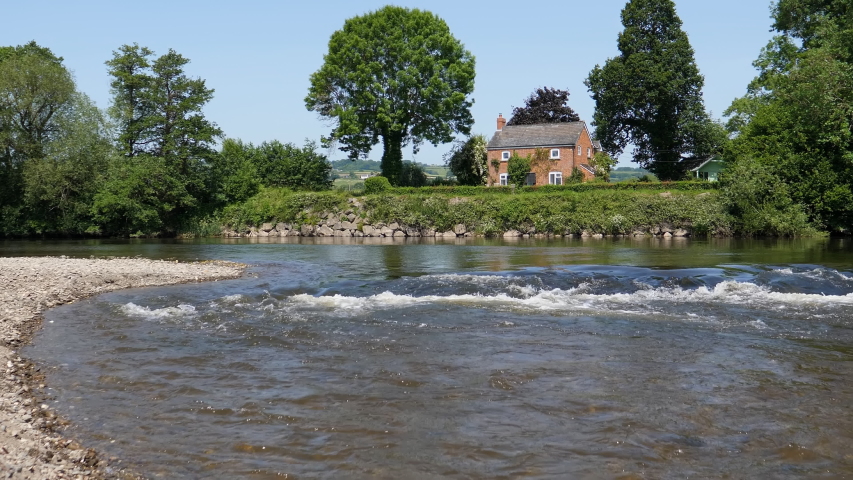 Low angle view of rapids on a sunny day in summer on river Wye in United Kingdom around Clifford.