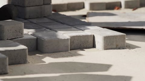 Close-up, Worker in gloves lays paving slabs