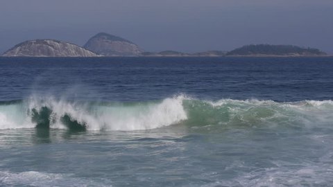 Waves breaking in the ocean at Ipanema beach, Rio de Janeiro, Brazil, smooth slow motion. 