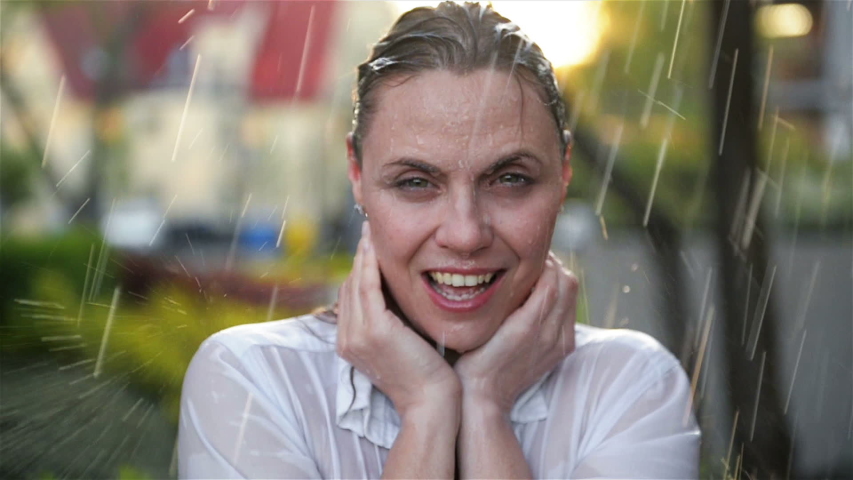 Happy Young Smiling Woman Having Fun In Rainy Weather. Cheerful Lady Has Wet Hair In Summer Park.