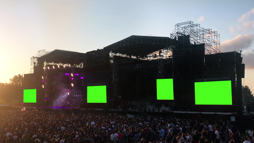 Crowd of Fans in a Concert Show with Green Screens.  You can Replace Green Screen with the Footage or Picture you Want with “Keying” effect in After Effects (check out tutorials on YouTube).