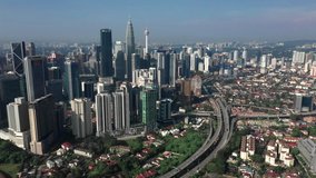 4k video of Aerial View Of Kuala Lumpur City Skyline During Day time with fly over motion camera movement with many building in the city