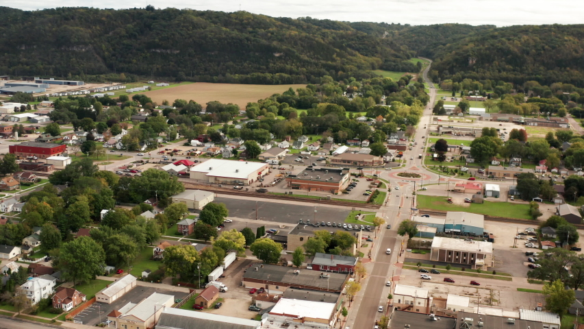  Aerial view of small american city.  Drone flying backwards along the street. Daytime, cloudy. Prairie du Chien, Wisconsin. 