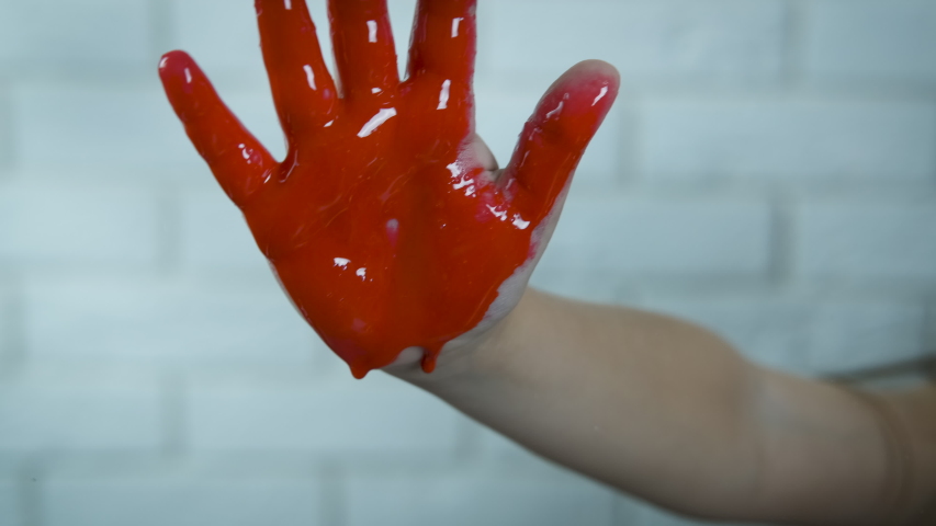 Child abuse. The hand is in the blood. The child