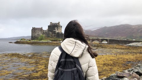Girl looking at Eilean Donan Castle