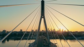 Aerial Geometry Pespective View of Suspension Bridge with Warsaw Cityscape, capital of Poland (Warszawa, Polska). Downtown Skyline at Sunset. 4K Pull out Background Drone view Video with Copy Space