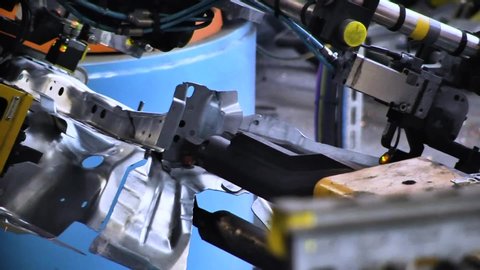 Automobile manufacturing industry. Robots soldering car parts on the production line