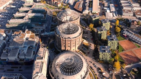 Aerial drone shot of Old Gasometer buidlings in Vienna from up above. Used like gasholders, it is music hall, museum, dormitory and shopping center howadays