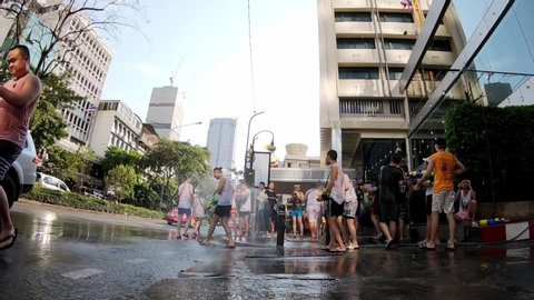 Bangkok, Thailand-April 14, 2019: Locals and tourists celebrate Songkran Festival, Traditional Thai New Year. People play water and use water guns to enjoy the festival.