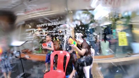 Bangkok, Thailand-April 14, 2019: Locals and tourists celebrate Songkran Festival, Traditional Thai New Year. People play water and use water guns to enjoy the festival.