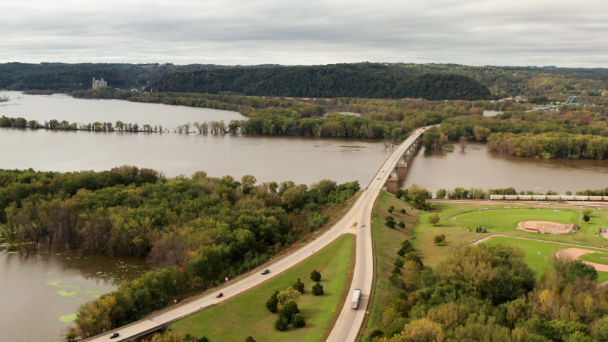 Aerial view of bridge road over the Upper Mississippi River in a small american city. Daytime, cloudy. Prairie du Chien, Wisconsin Minnesota border. 