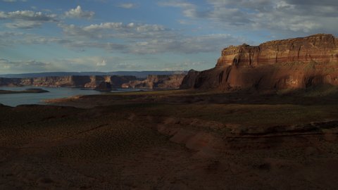 Zoom in to distant lake and cliffs in remote desert / Glen Canyon, Utah, United States