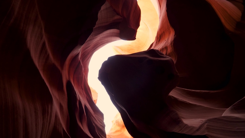 Antelope slot canyon with smooth and wavy sandstone walls orange red colors. Camera is pointing up and shooting turn around in place. Graceful curves and stunning place in Arizona USA Royalty-Free Stock Footage #1040927288