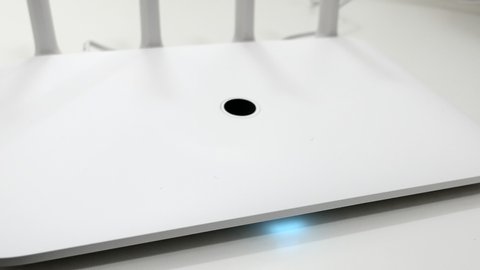Bokeh White Wireless Wi-Fi Router On The White Desk Panning Slider Shot.