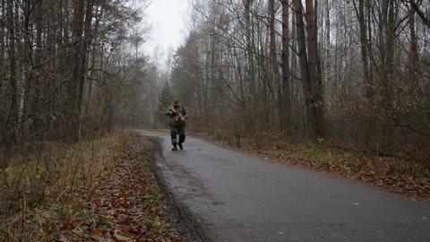 Soldier walking through autumn forest hd stock footage
