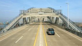 Drone footage of the Bayonne Bridge viewed from road level, with pull back motion. The Bayonne Bridge is an arch bridge spanning the Kill Van Kull connecting Bayonne, NJ with Staten Island, NYC