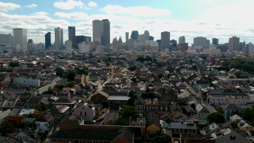 aerial drone footage of New Orleans City downtown area during clear blue sunny skies mid afternoon.  the old skyscraper building architecture has beautiful view for tourist to travel to and enjoy 