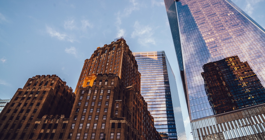 Below view of metropolitan facade in business center of big city with modern infractructure, time lapse effect of residential buildings in disctrict with commercial corporate constructions
