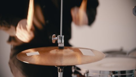 A man from the musical band playing drums