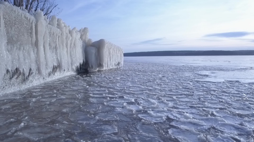 frozen icicles on the riverside, slow mooving