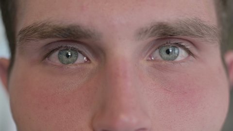 Close Up of Young Man Blinking Eyes in Camera