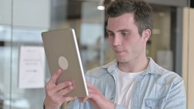Portrait of Young Designer doing Video Chat on Tablet