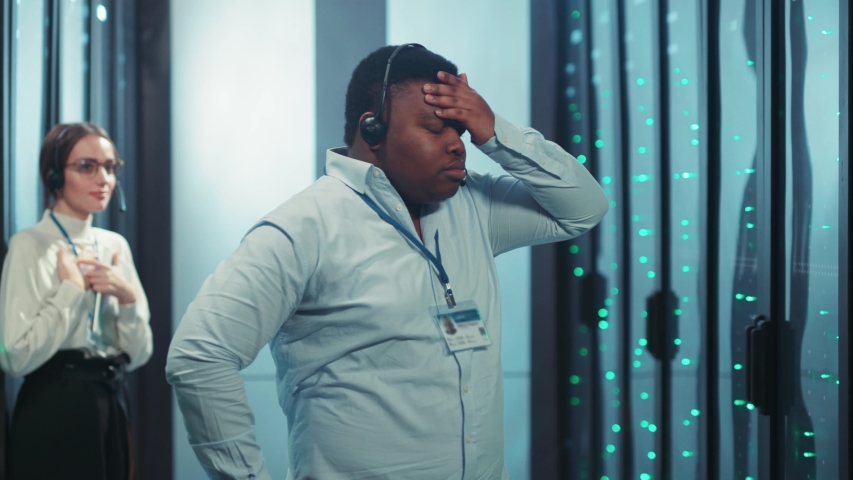 Nervous afro-american administrator getting mad stress writing notes feeling deep pressure going crazy throwing things in server room. Stressful job. Data center. - Powered by Shutterstock - Get 15% off with code: PIKWIZARD15