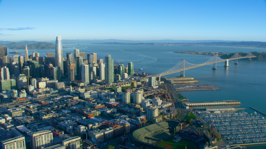 Great aerial view of San Francisco skyscrapers. City skyline, piers and bridges.  Oakland Bay Bridge. California, United States. Shot on Red weapon 8K.