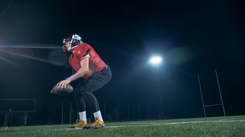 American football players competing on a field, close up.