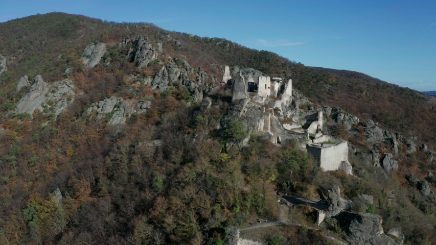 aerial drone shot, circling around Dürnstein Durnstein ruin medival castle, looking at the Danube river, in the hills of Wachau valley, Lower Austria in fall autumn season 4K