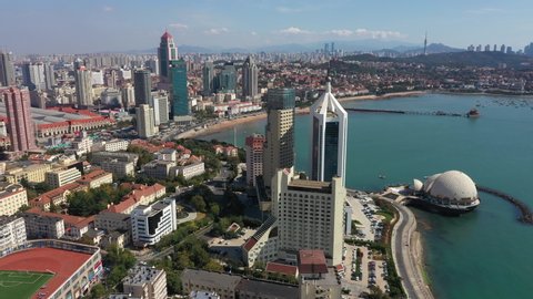 QINGDAO, CHINA – SEPTEMBER 2019: Panoramic drone flight of central Qingdao, a seaside city popular with holidaymakers in China
