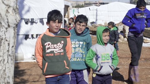 January 2017 - Beqaa Governorate, Lebanon: Syrian children smile and wave to camera at a refugee camp