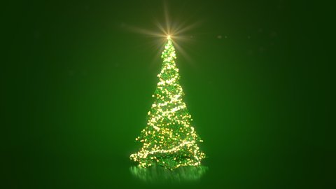 Rotating Christmas tree from glow shiny particles and baubles on green background. Christmas or New Year background with copy space. 
