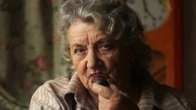 Happy elderly woman eating chocolate candy and smile slow motion - Powered by Shutterstock - Get 15% off with code: PIKWIZARD15